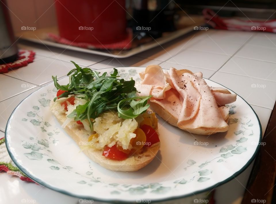 My favorite sandwich is turkey on cracked wheat sour dough bread with dijon mustard arugula sauerkraut pickles tomatoes in my kitchen for lunch