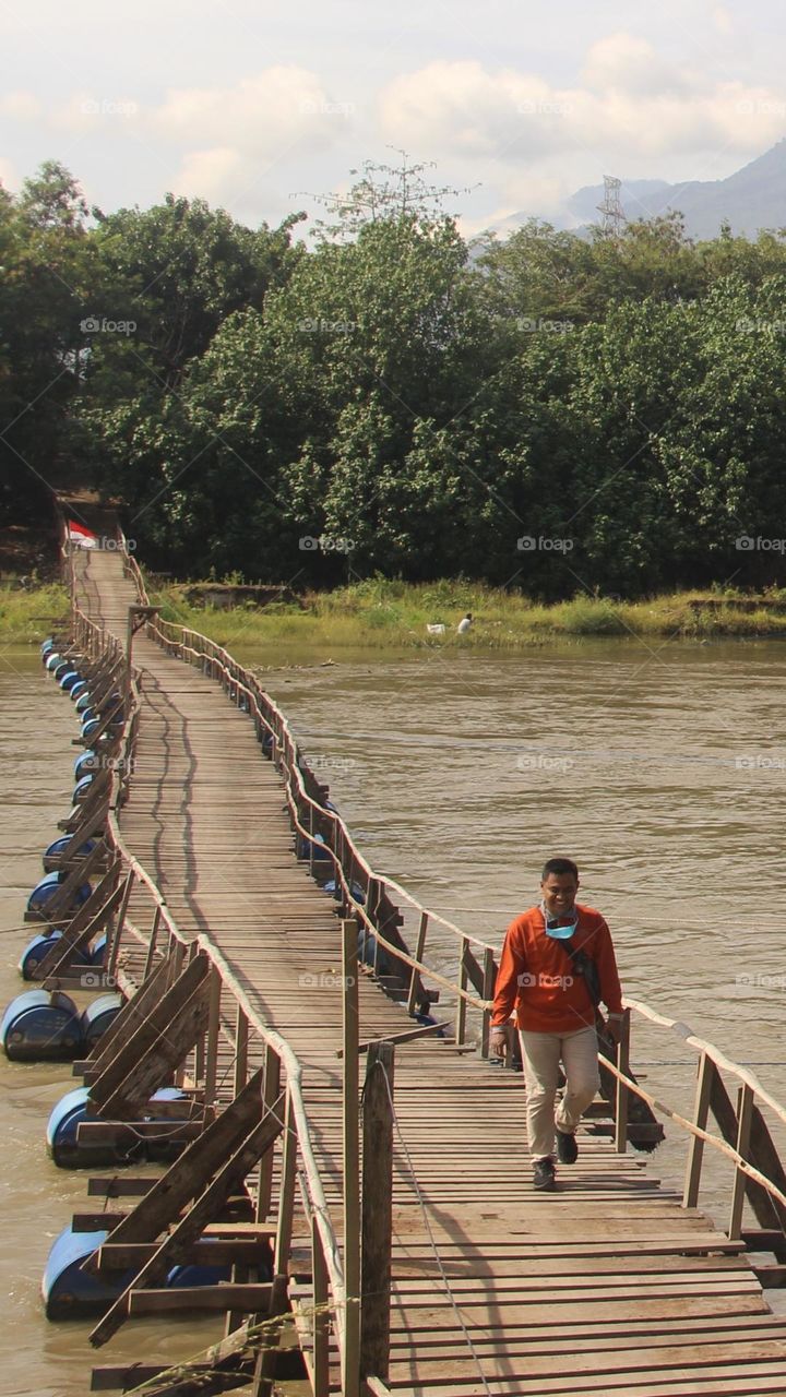 Walking on the wooden bridge over the river