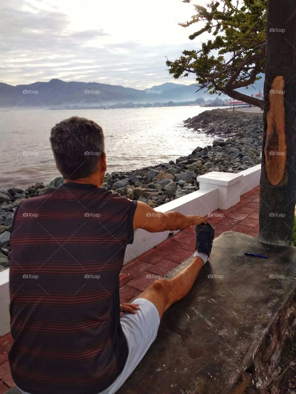 Morning exercise by the beach,  stretching out with a beautiful view, from Farol,  Díli,  East Timor