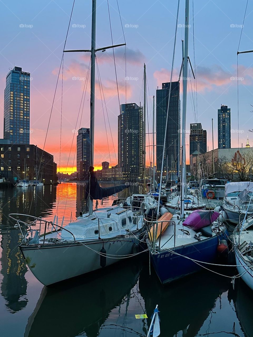 This is “Newtown Creek” by the “Pulaski Bridge” in LIC, at sunset just before nightfall seen from the front deck of “Salvation”, the “28 ft 1969 Luhrs” cabin cruiser that is home to myself and partner “Timothy Trespas”. 2024. Hypnotic Productions