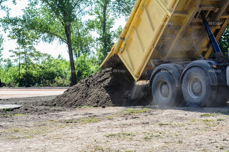 Truck unloading the sand. truck on construction site