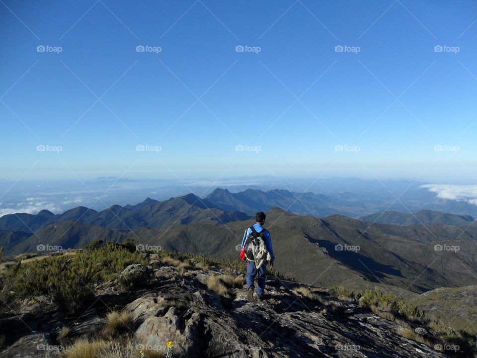 Rear view of a man standing on the mountain