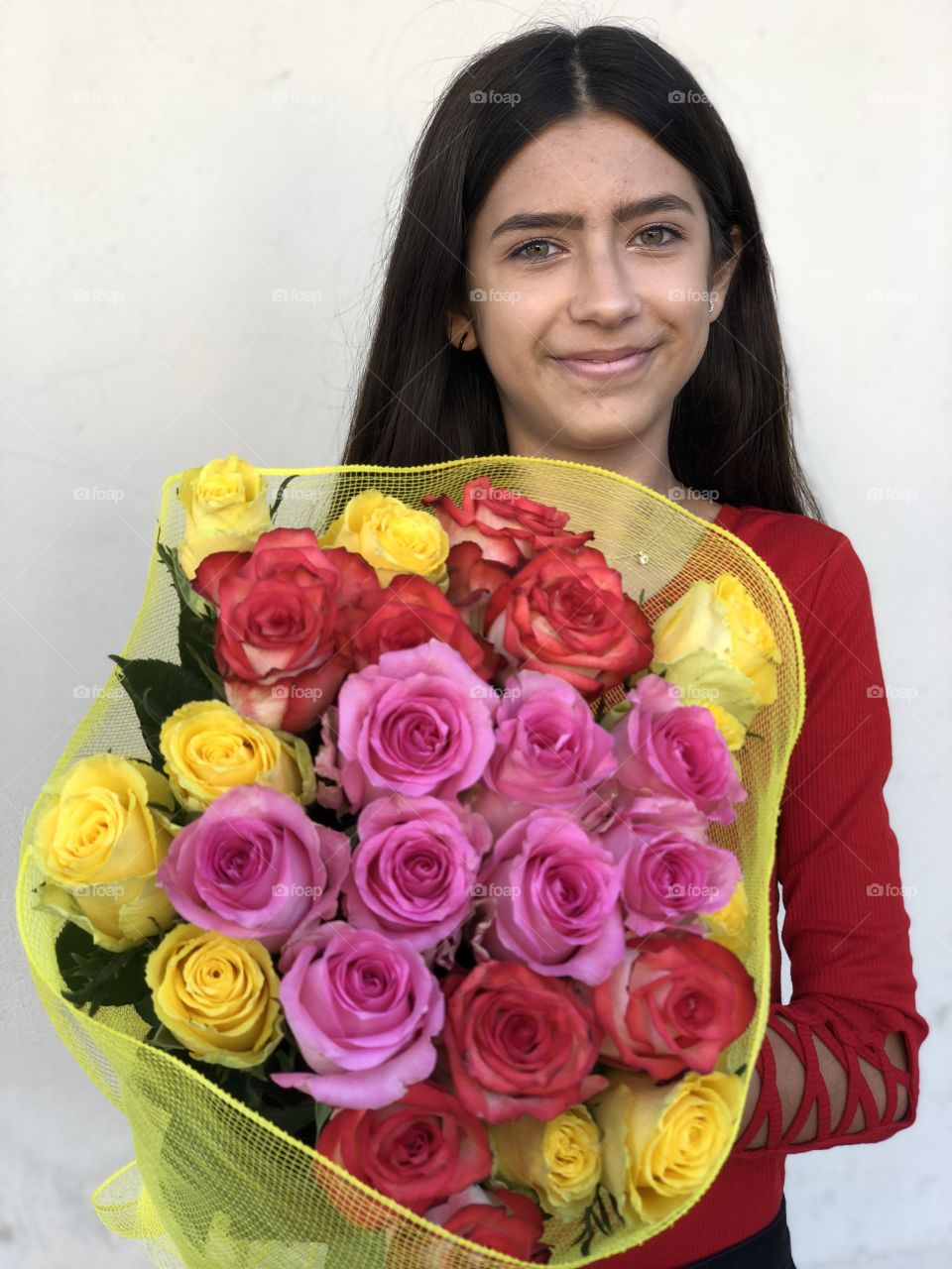 Young girl with a colorful bunch of roses