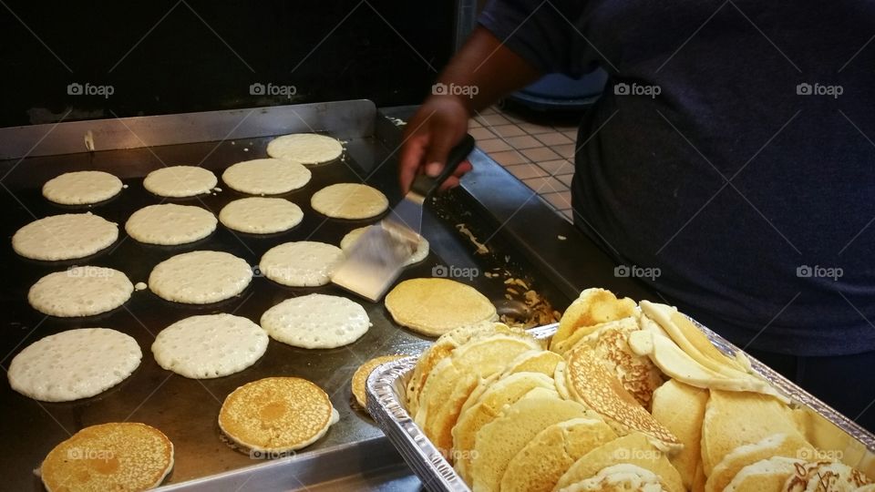Chief making pancakes in kitchen