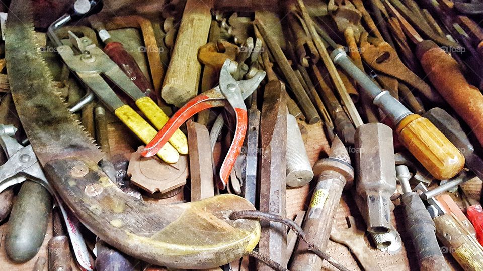 Old tools jumbled together with dust between their moving parts from the days of their prime.