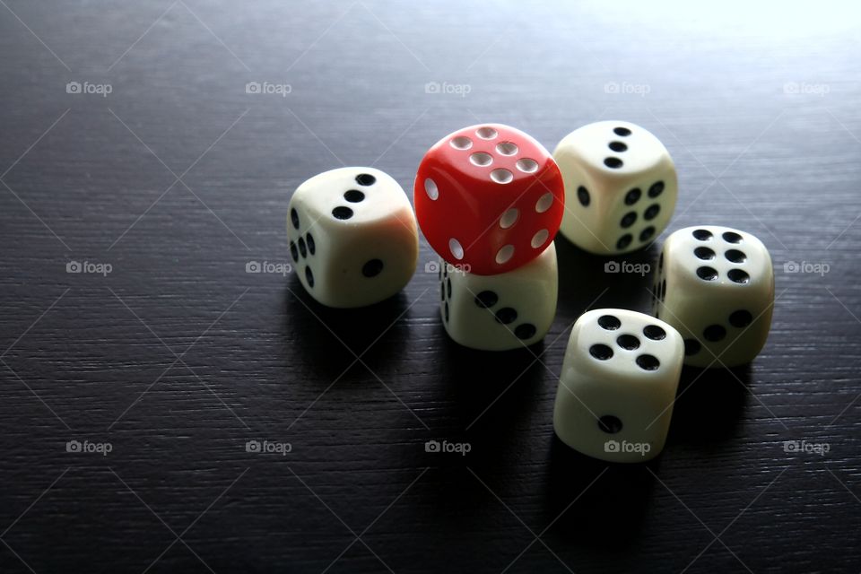 1 red dice among 5 white dice. photo of 1 red dice among 5 white dice