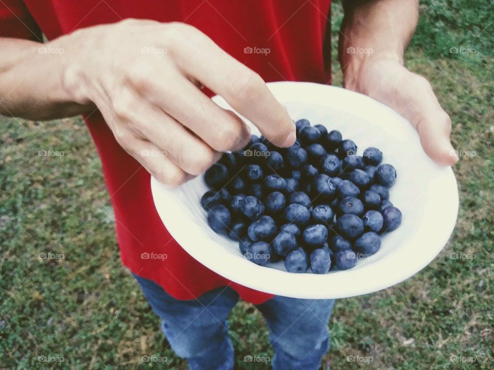 Man snacking on blueberries
