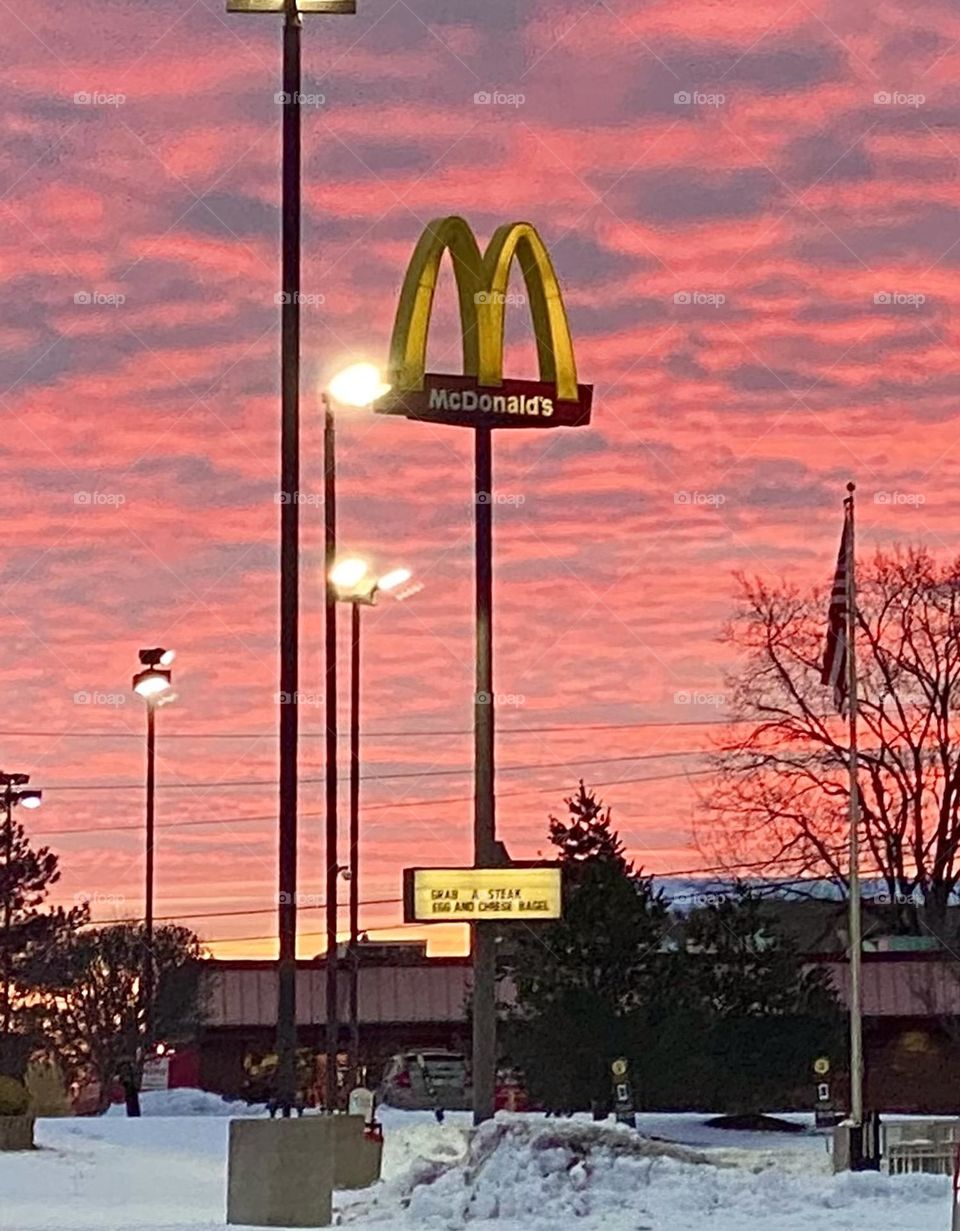 McDonald’s at sunrise, the Golden Arches against beautiful pink clouds