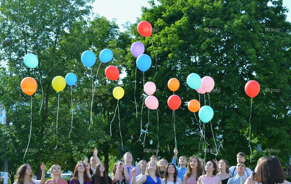 colour balloons flying and people