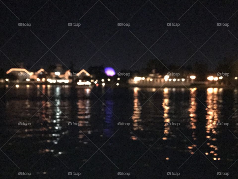 Cool blurry lights reflecting on beautiful pond in Walt Disney world 