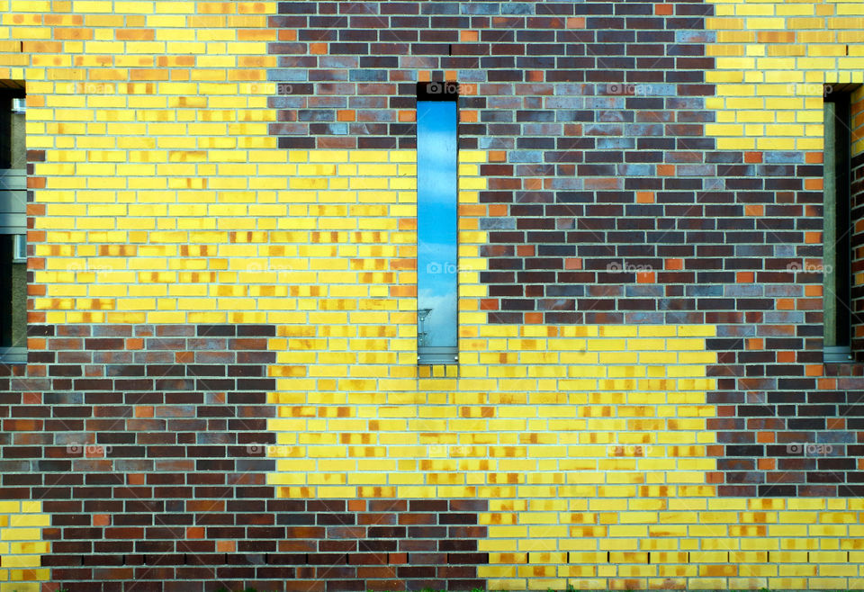Close-up of yellow colored brick wall.