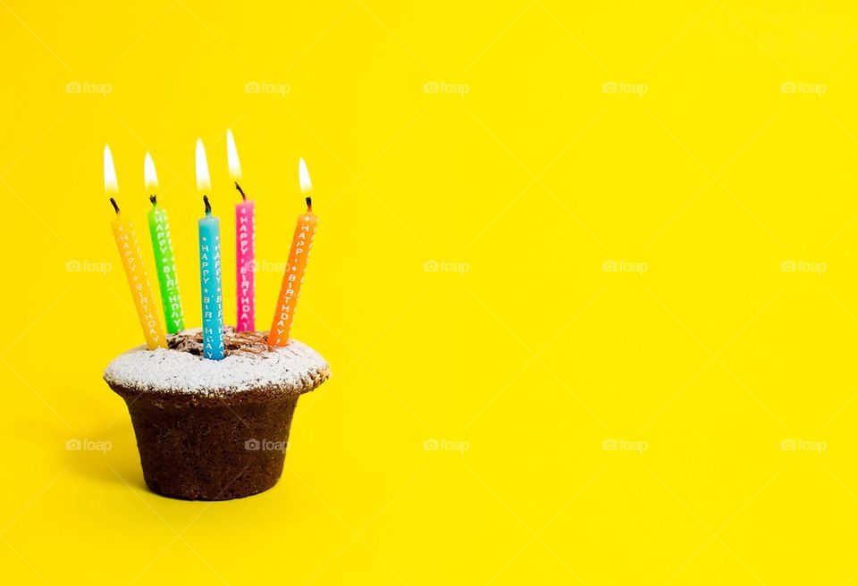Birthday cake on yellow background
