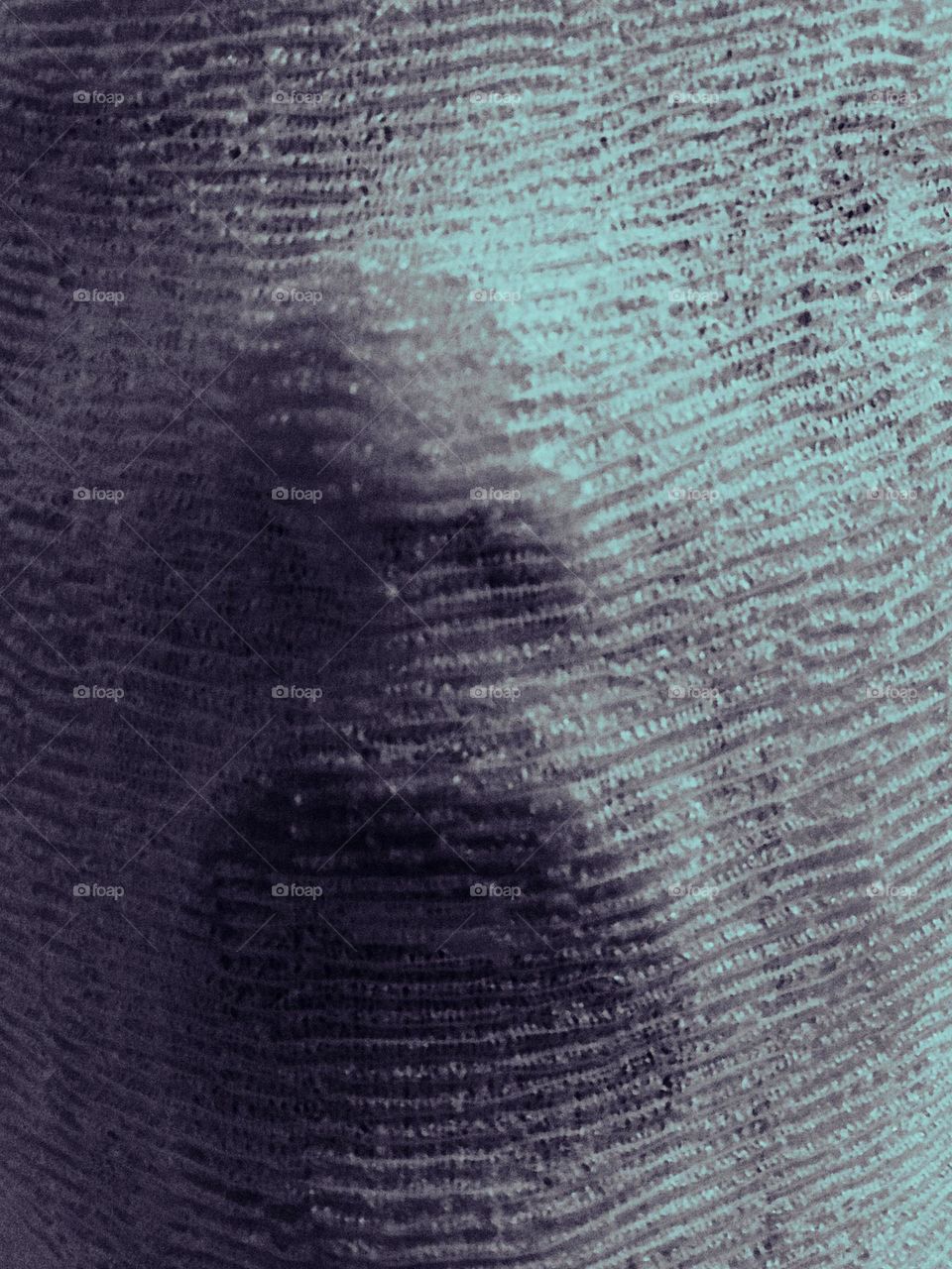 Blue monotone closeup of a woman’s face tightly bound in nearly opaque cheesecloth-like wet fabric. The selfie shows mostly the nose and open mouth. She looks like she’s gasping for air or in fear. You can see the slightest dark shadows of the eyes. 