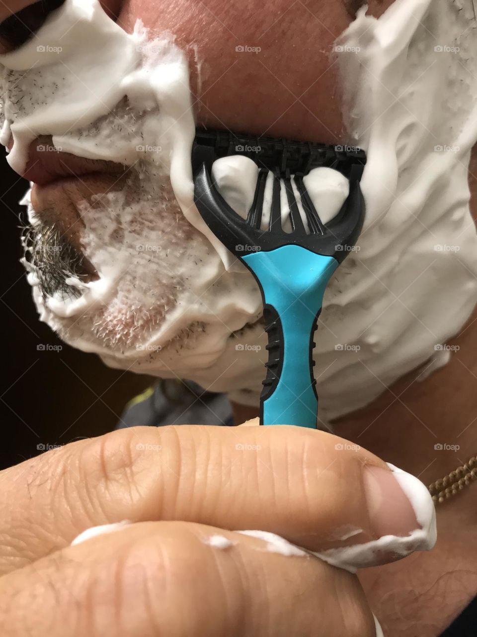 shaving with face foam close up