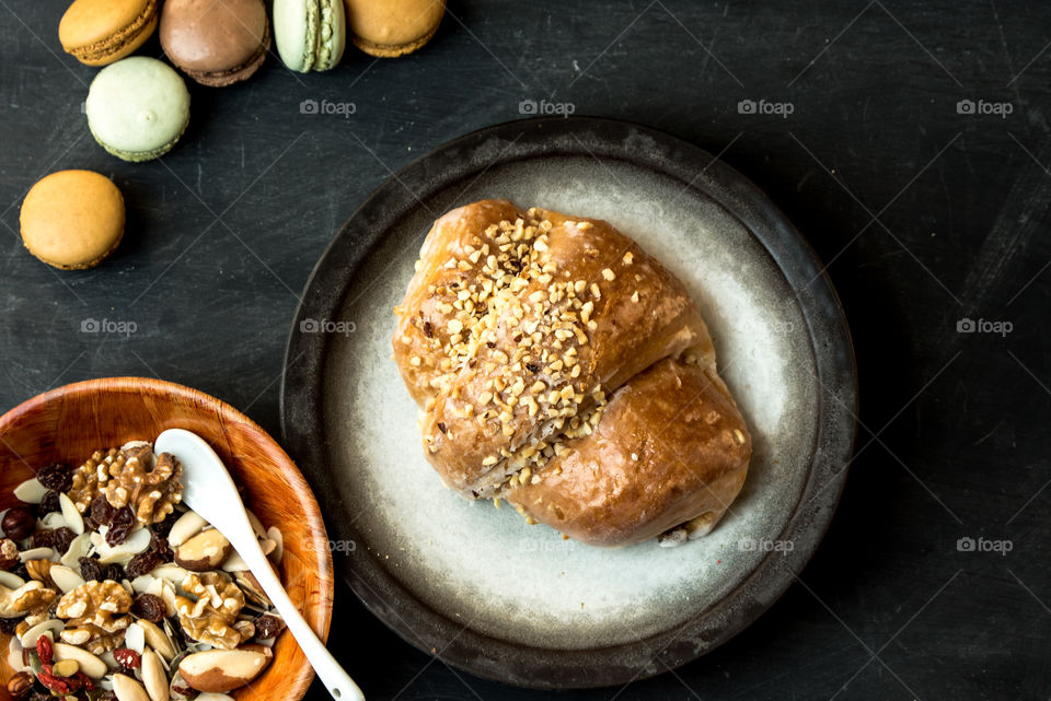 sweet bagel with nuts, a fragment of a table with breakfast