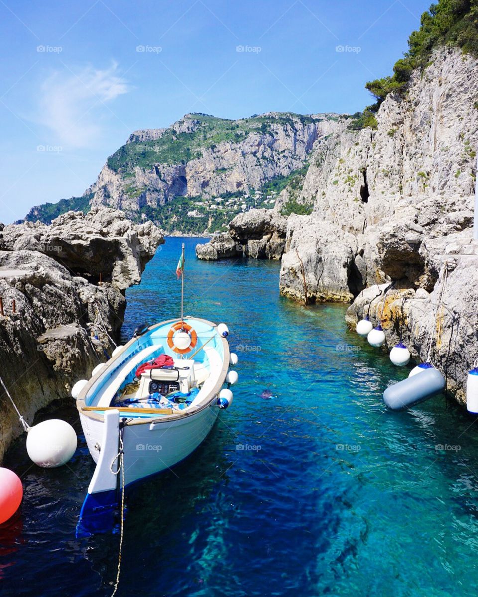 Tiny boat near the Faraglioni in Capri.