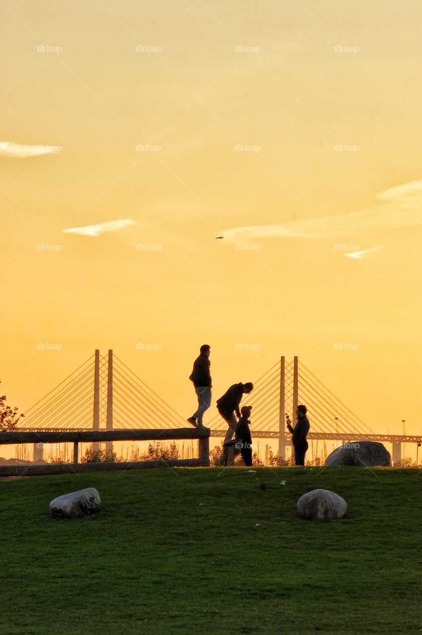 Silhouettes by the bridge