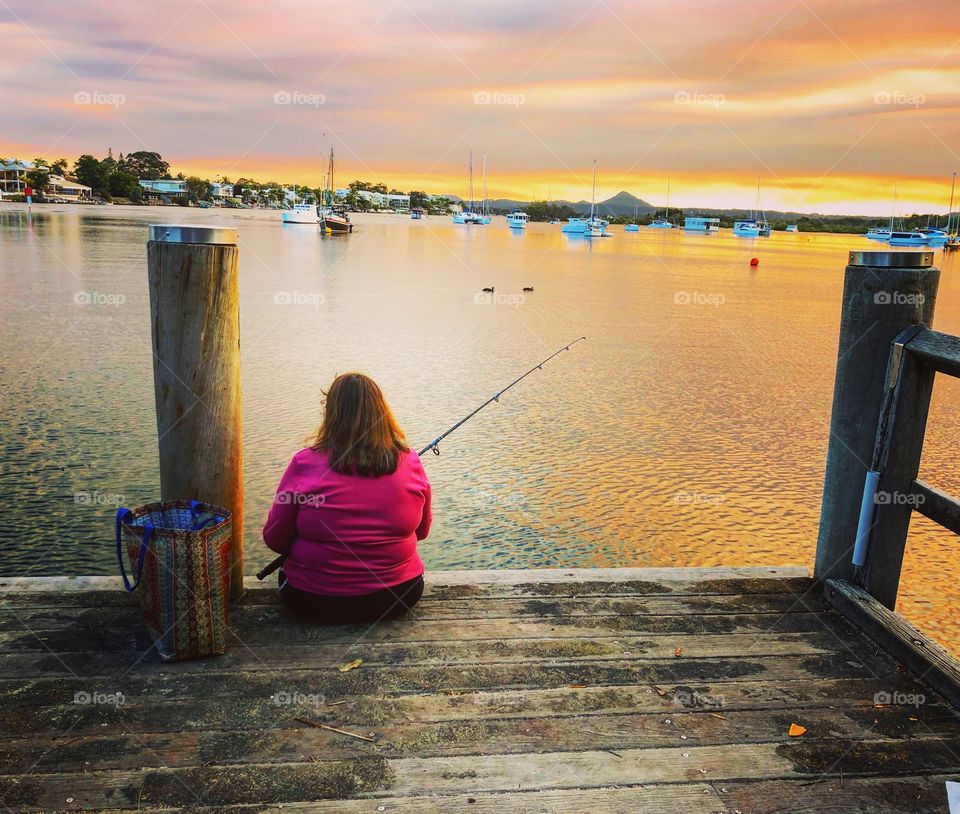 Fishing on the jetty in the evening light lady with pink toP