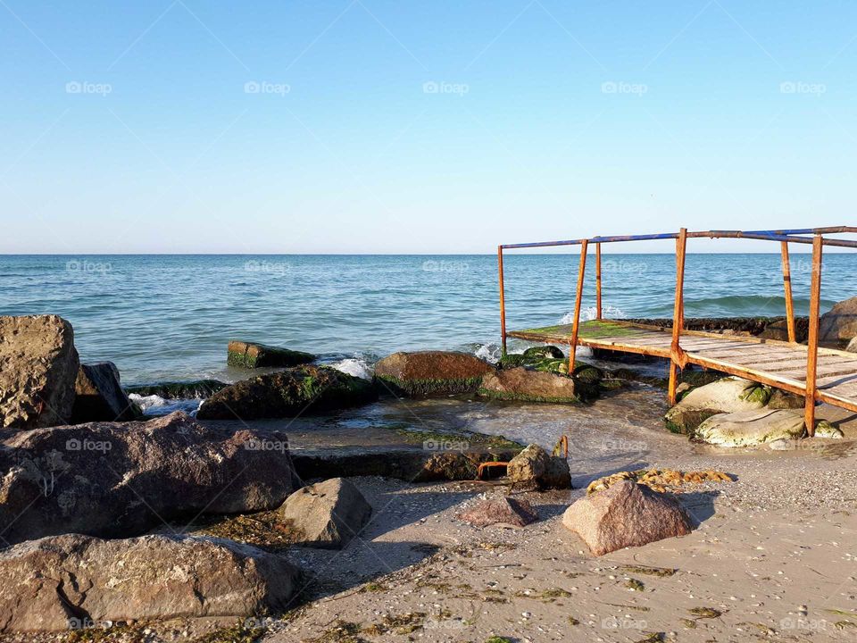 Wooden bridge and rocks at the beach