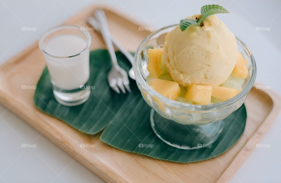 mango ice cream topped with coconut milk