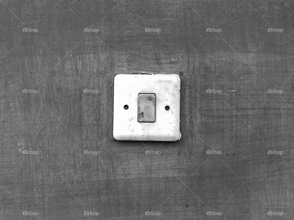 Dirty white light switch in black and white