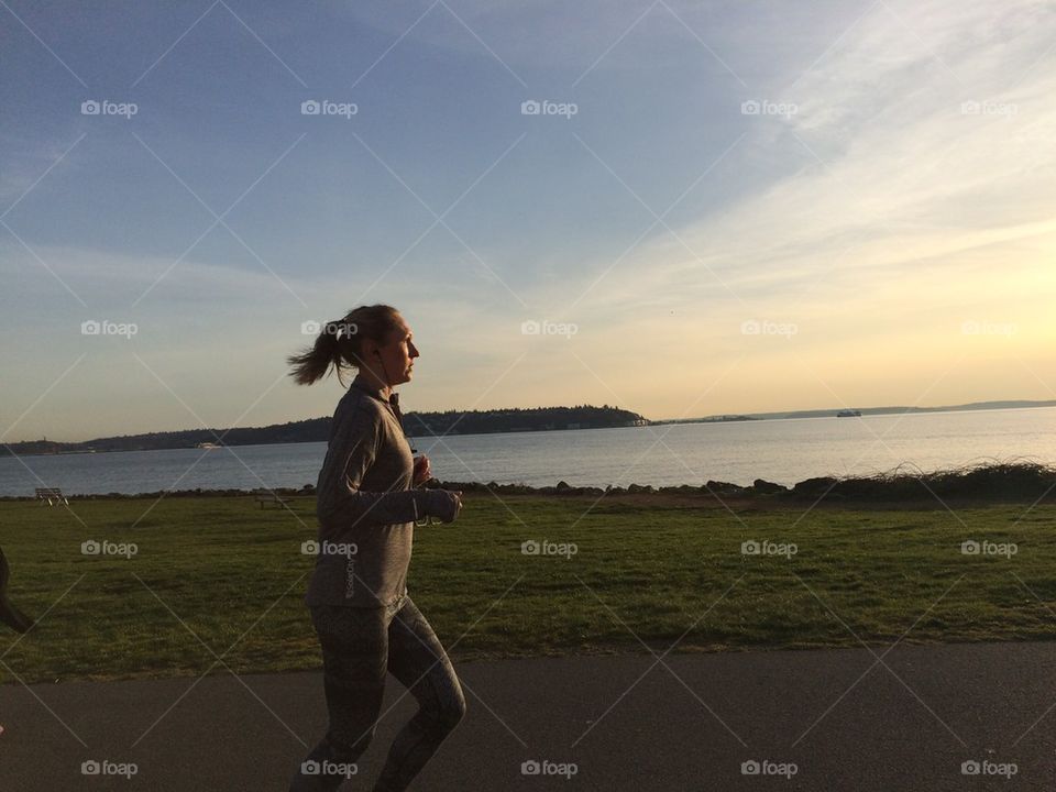 Woman running at sunset