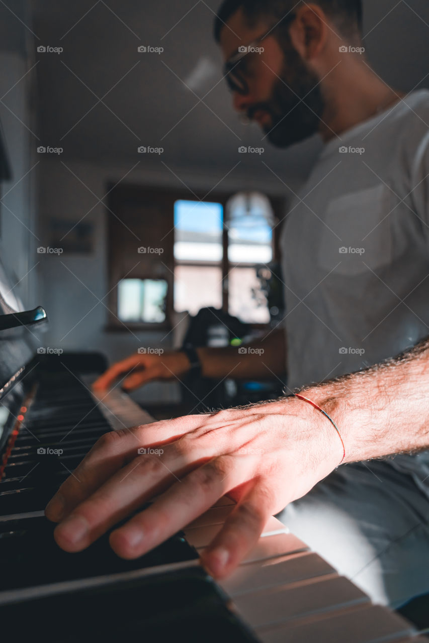 Hands playing a piano