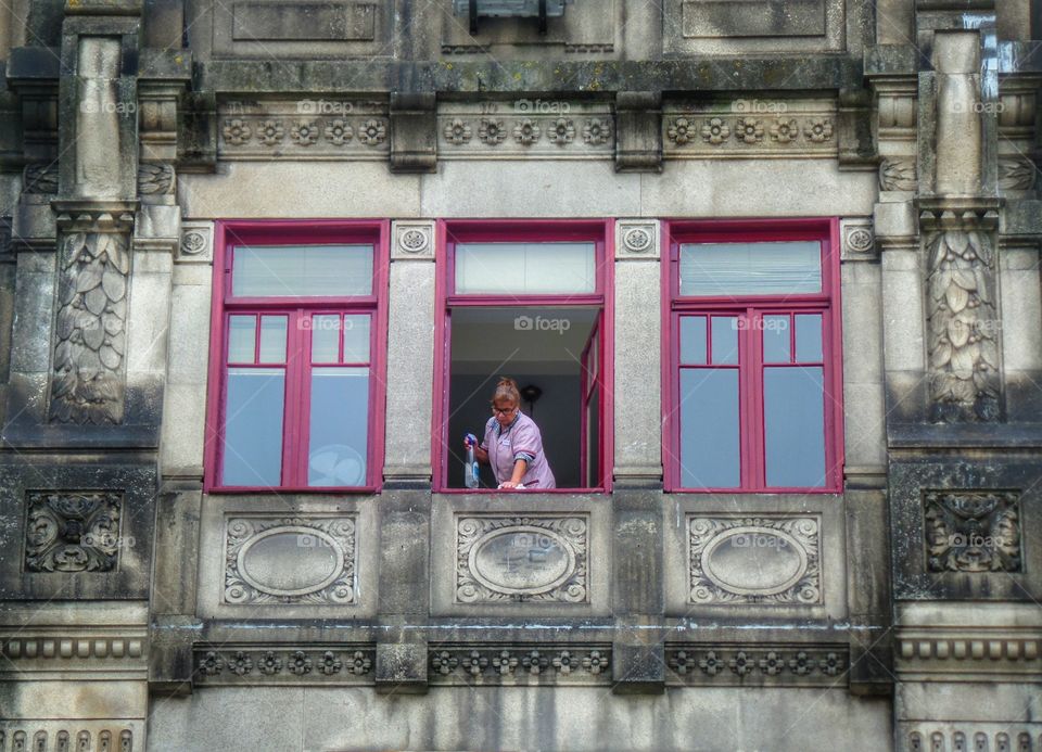 Cleaning the facade?. Walking down Liberdade Place in Porto, Portugal