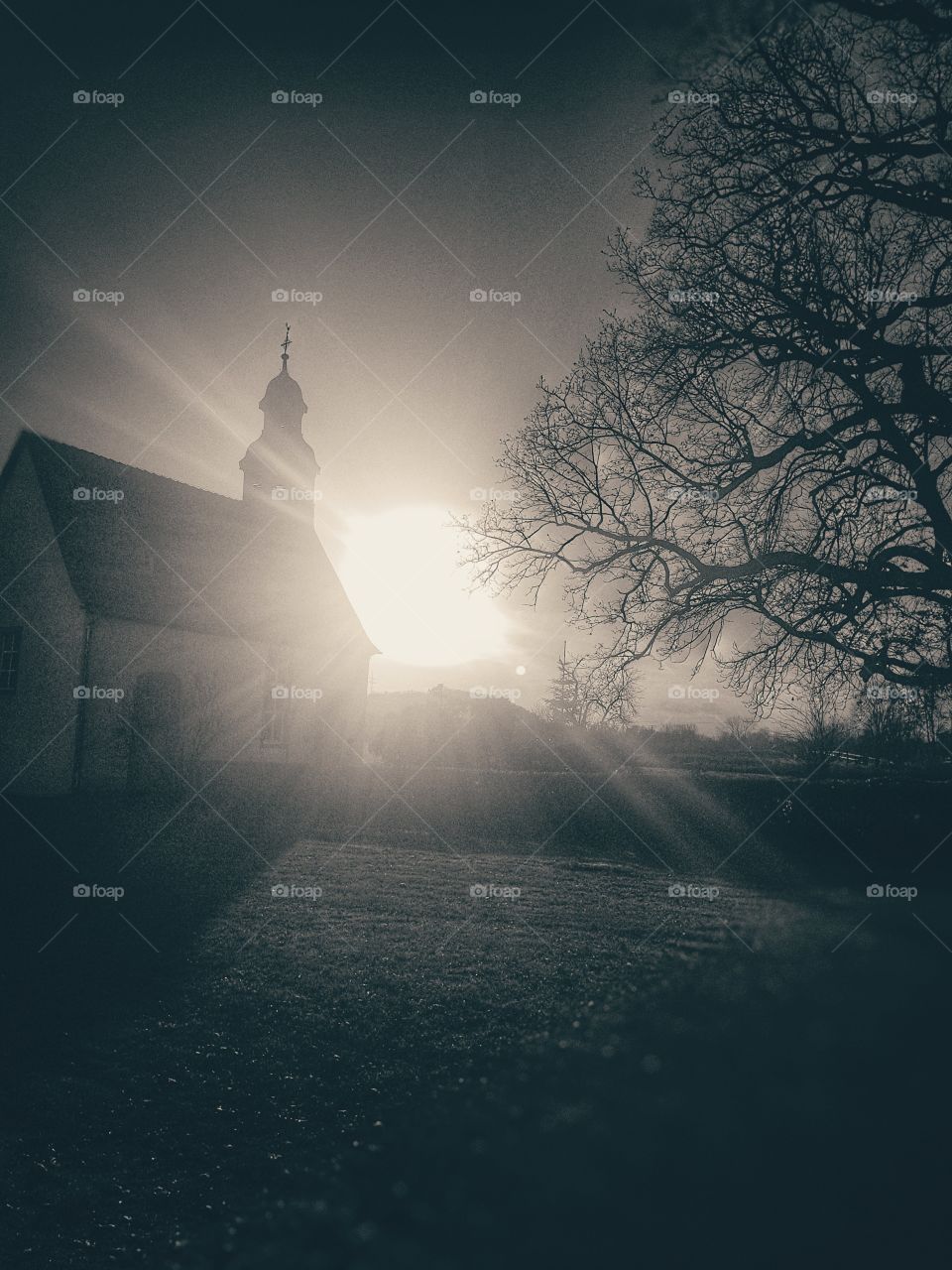 sundown behind a church bw