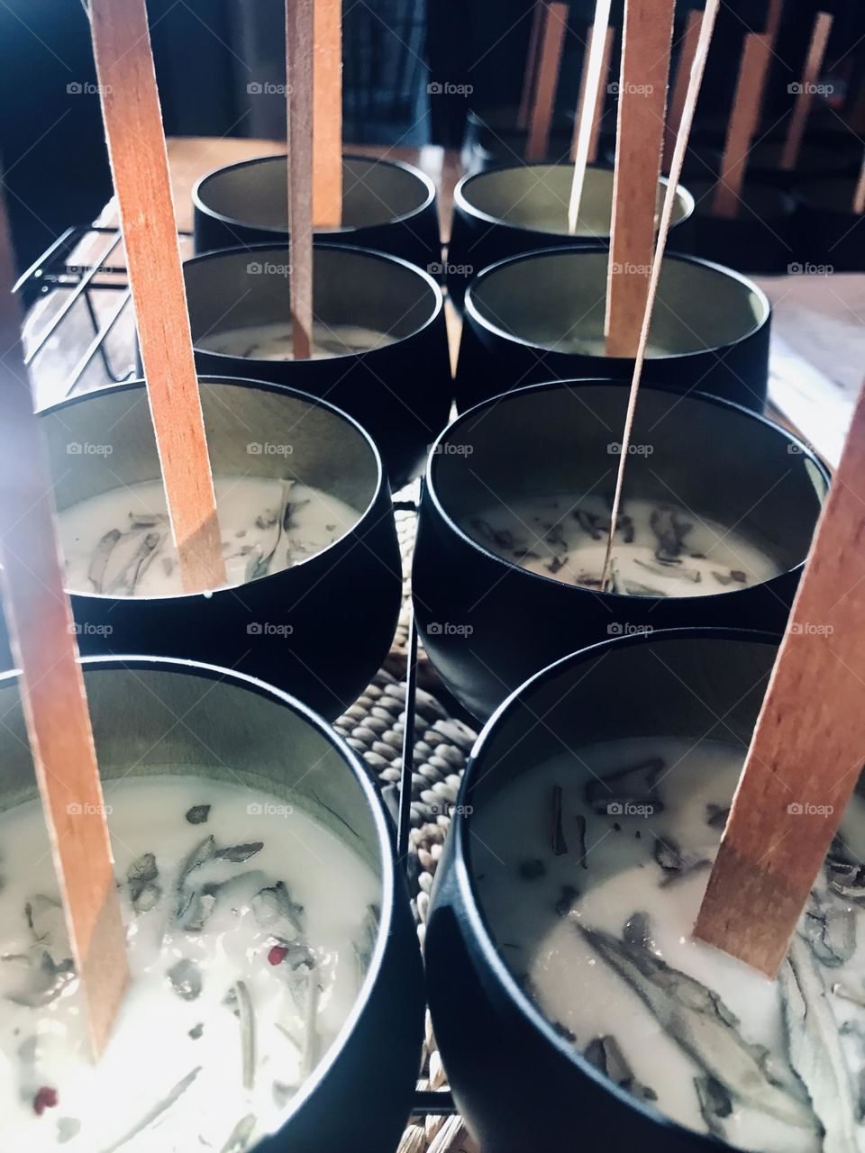 Close up of candles in progress on cooling rack in sunlight 