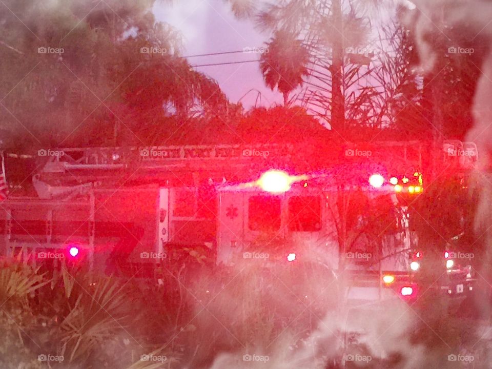 Fire engine. The lights from the fire engine are glowing through the smoke.