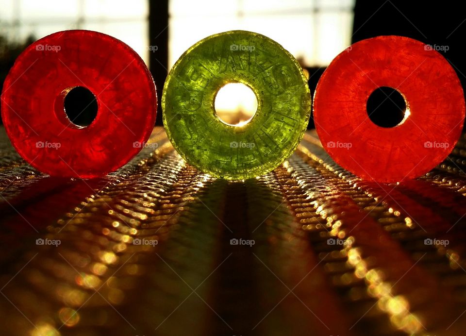 Color love lifesavers in red orange and green in a window at sunset