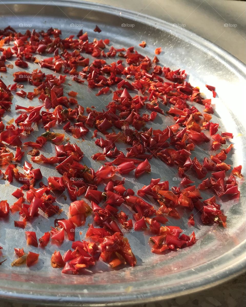 Are these a handful of red bell peppers waiting to dry up or a school of free red fishes swimming in silver waters? Where is the borderline between reality and fantasy, between despair and hope?