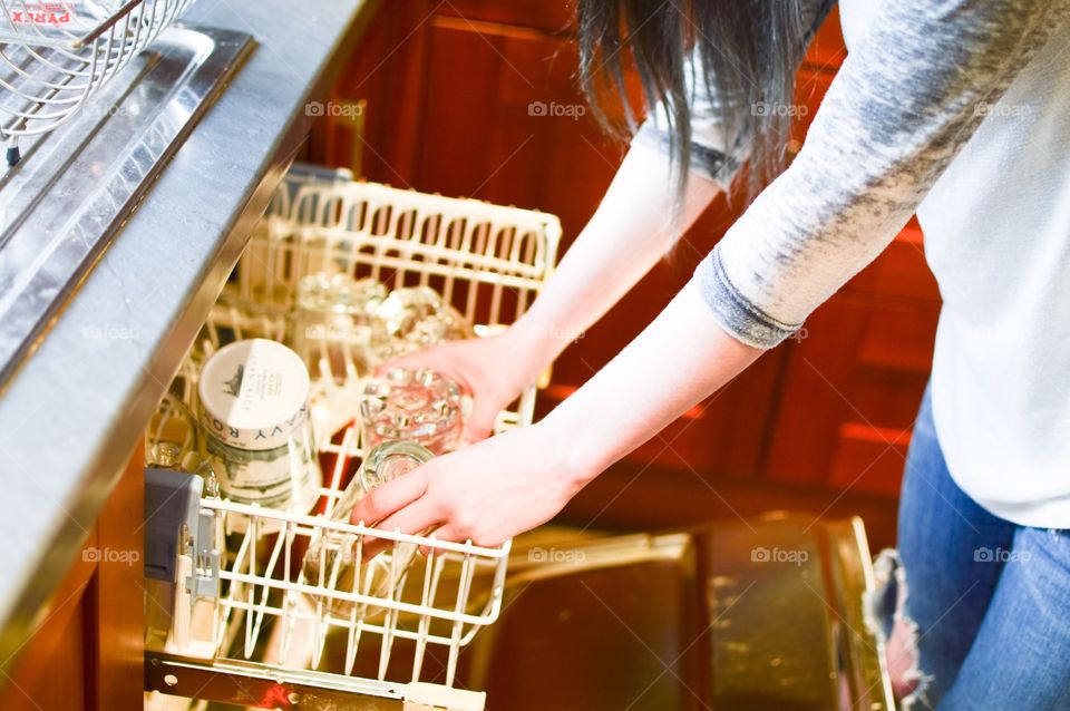 Women removing drinking from dishwasher