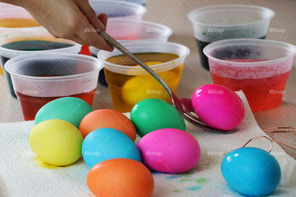 Child coloring Easter Eggs