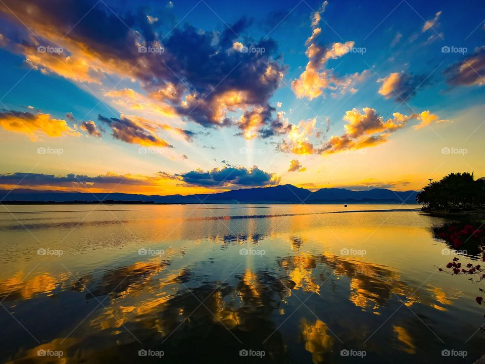 A sunset reflection over Phayao Lake in Phayao, Thailand. The sky was appeared to be on fire!