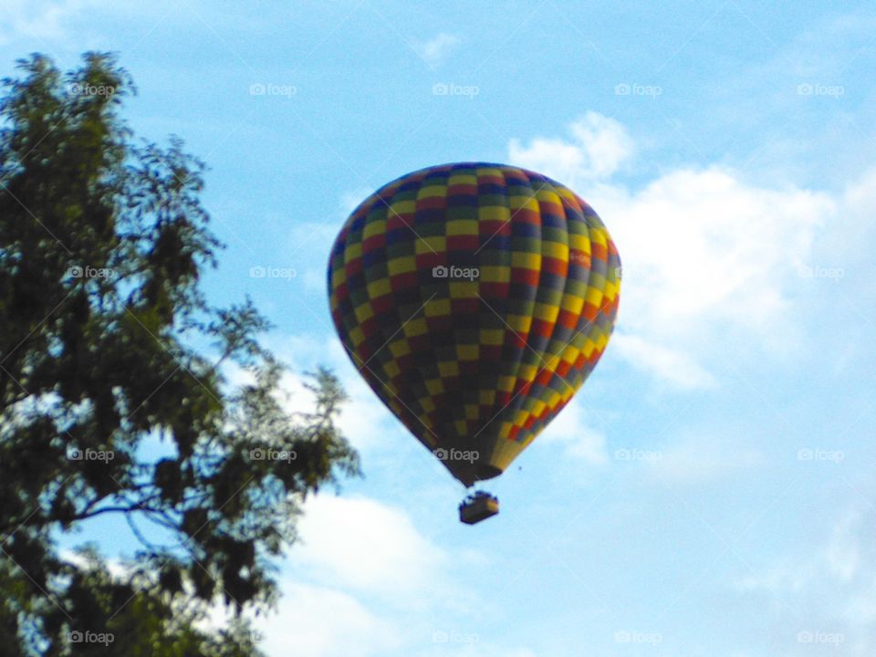 A hot air balloon gliding over the Cornish town of Launceston 