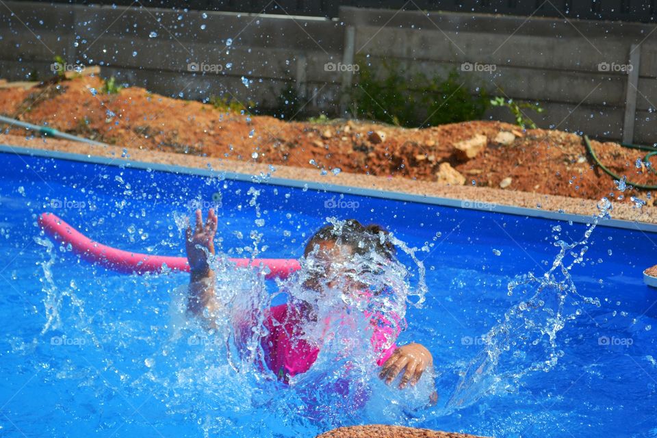 Child splashing in pool. Child splashing in swimming pool