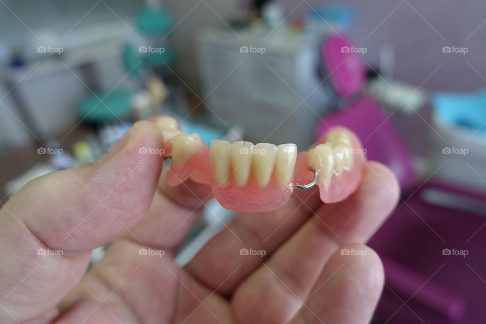 Dentures in hand