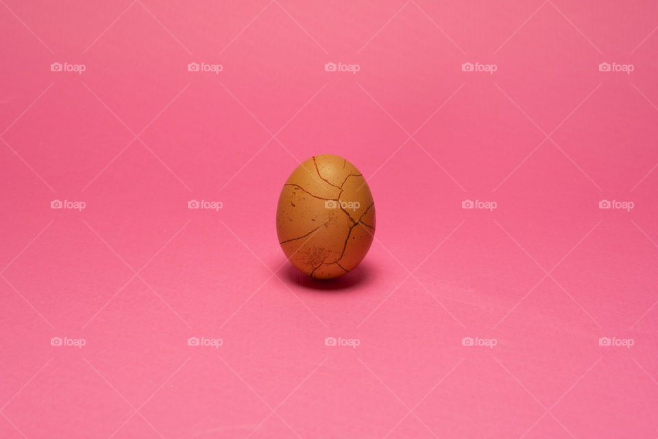 Organic egg with cracked like paint. Easter background