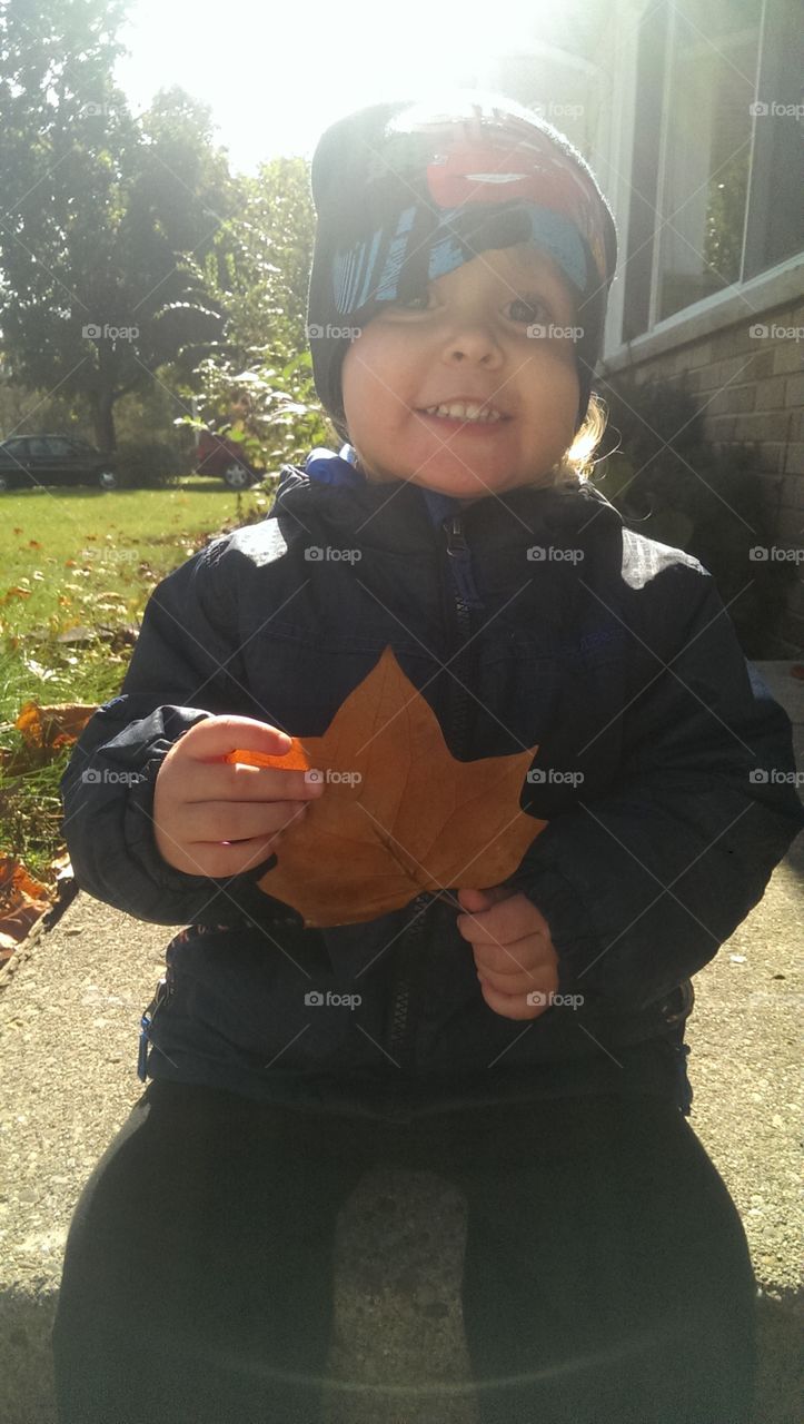 toddler boy fall day holding a leaf