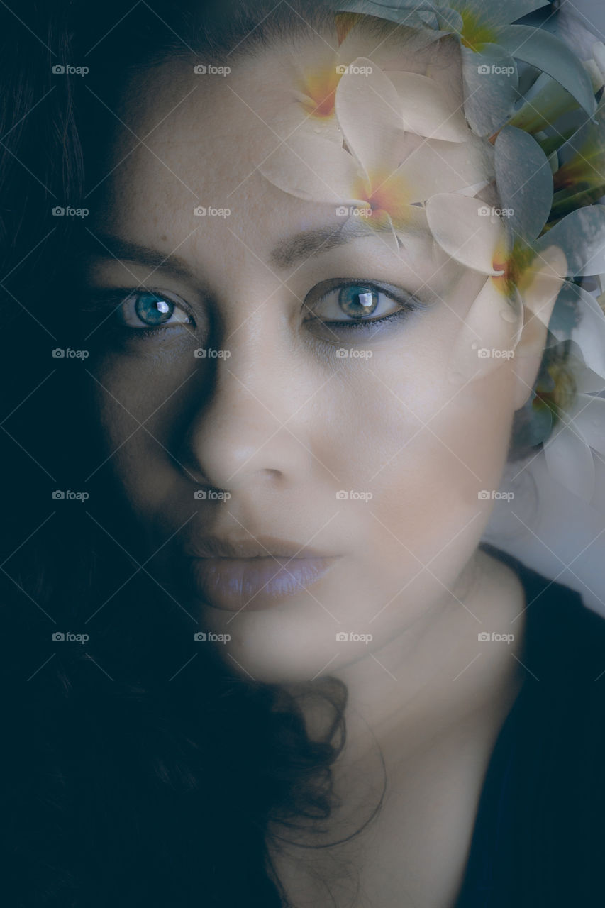 Multiple exposure of woman's face with flowers