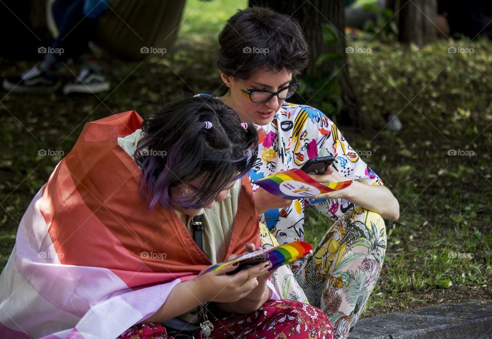 Teens using phones at the street