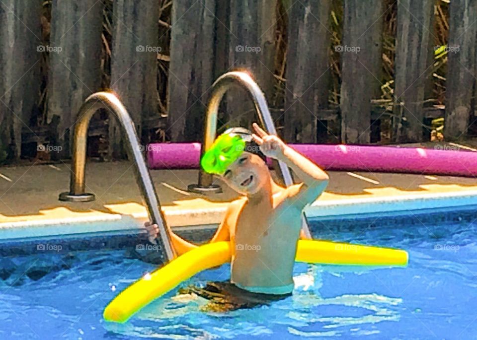 Smiling boy enjoying in pool