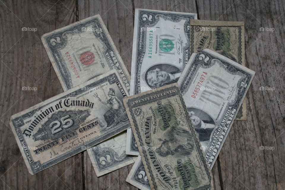 Unique money 2 dollar bills and Canada bills pile