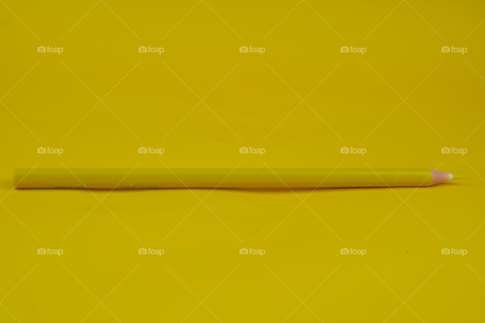 yellow pencil on a yellow background
