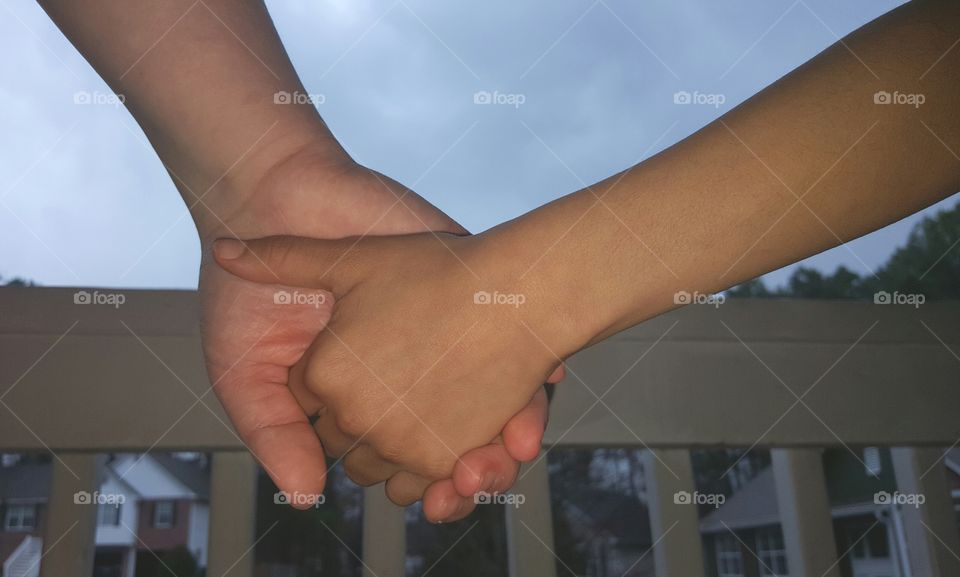 Two people holding hands