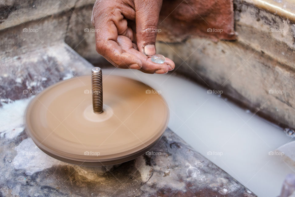 Man's hand preparing gemstone