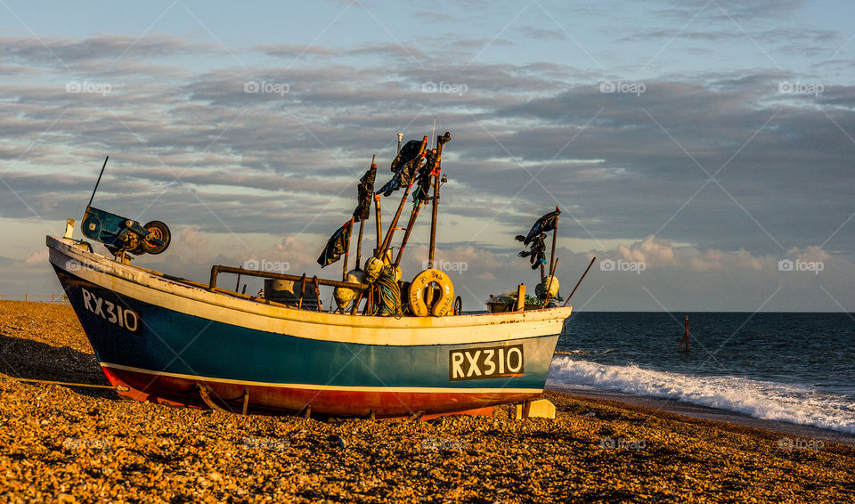 Hastings fishing boat RX310, close to the shore on the pebbled fisherman’s beach at Hastings UK 