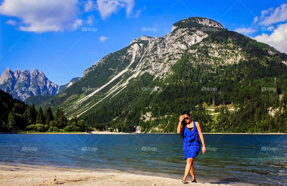 Young woman walking near lake side